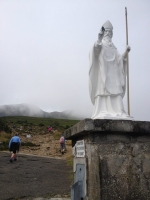 At the bottom of the Reek, St Patrick welcomes you with a leaf clover, a symbology of the trinity, in agnostic words birth, death and resurrection — at Croagh Patrick.