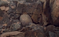 An erratic granite bolder dated 2.4 billion year stuck in the rocks in Canada