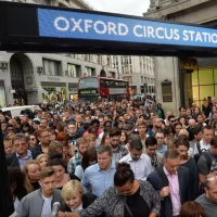Overpopulation is an issue. People entering a train station in London going to work. They are willing to let somebody else to exploit the resources of other countries for a better quality of living in their own areas